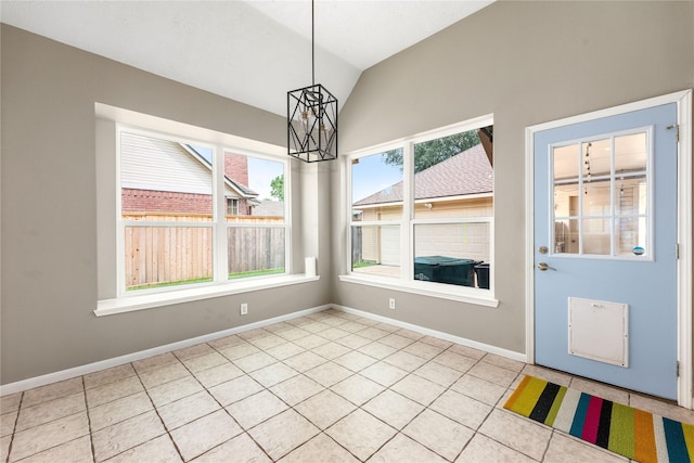 unfurnished dining area with an inviting chandelier, light tile patterned floors, baseboards, and lofted ceiling