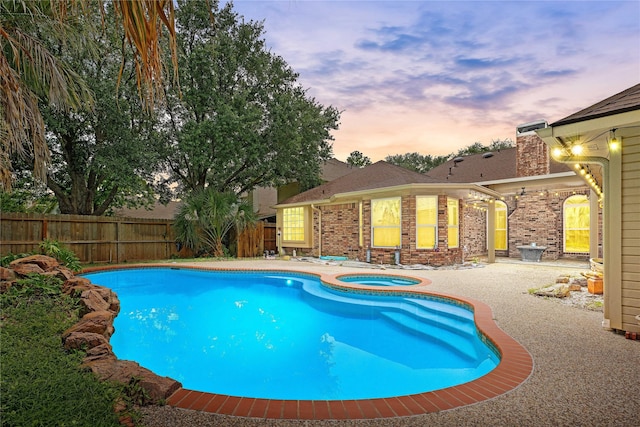 view of pool featuring a patio area, an in ground hot tub, a fenced in pool, and fence