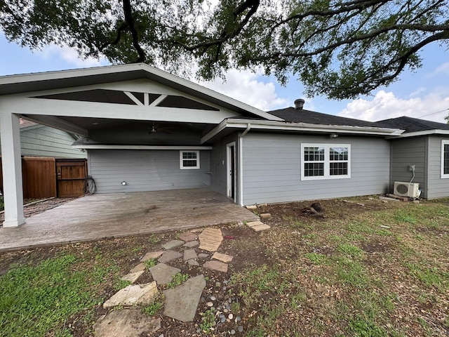 rear view of house featuring fence, ac unit, a ceiling fan, and a patio
