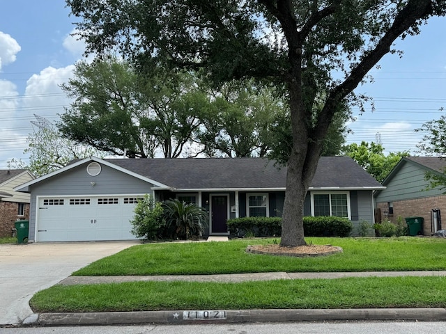 ranch-style home with an attached garage, a front lawn, and driveway