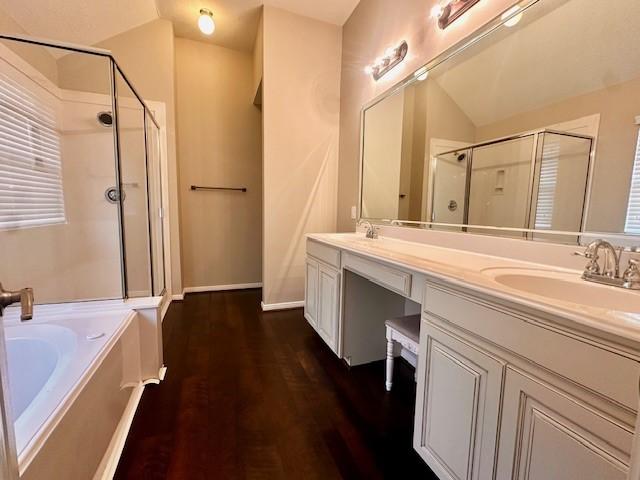 2407 Florence Dr, League City, TX 77573 - bathroom featuring a sink, a shower stall, double vanity, and wood finished floors