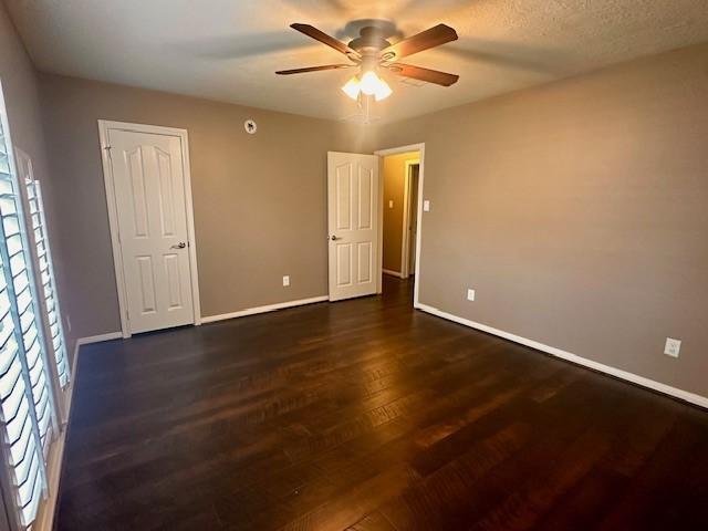 2407 Florence Dr, League City, TX 77573 - empty room with dark wood-style flooring, baseboards, and ceiling fan