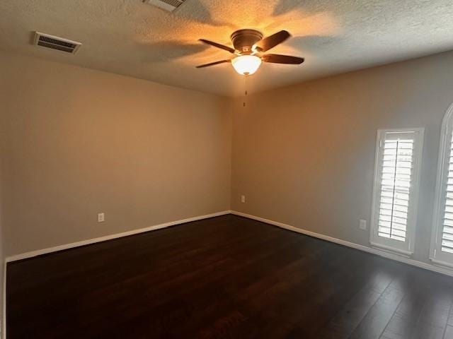 2407 Florence Dr, League City, TX 77573 - empty room with visible vents, dark wood-style flooring, a ceiling fan, and a textured ceiling