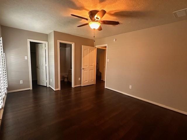 2407 Florence Dr, League City, TX 77573 - unfurnished bedroom featuring dark wood-type flooring, visible vents, baseboards, and a textured ceiling