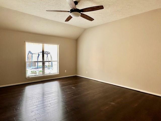 2407 Florence Dr, League City, TX 77573 - unfurnished room featuring ceiling fan, baseboards, dark wood finished floors, and lofted ceiling