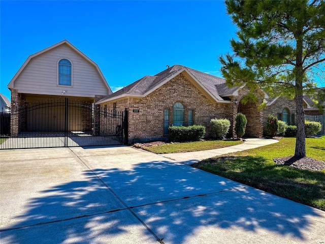 2407 Florence Dr, League City, TX 77573 - view of front of home featuring a gate, driveway, a front lawn, brick siding, and fence