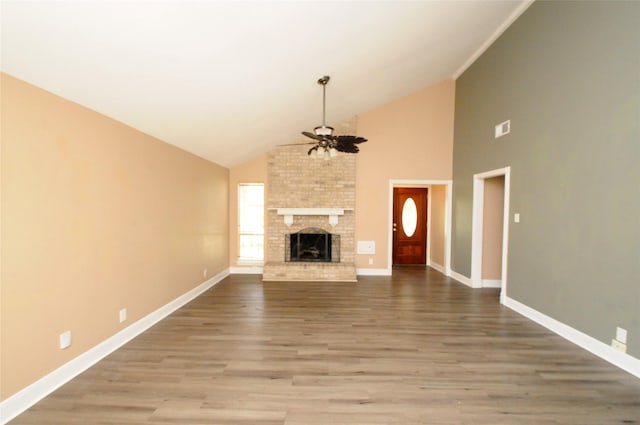 unfurnished living room featuring a fireplace, a ceiling fan, visible vents, baseboards, and wood finished floors