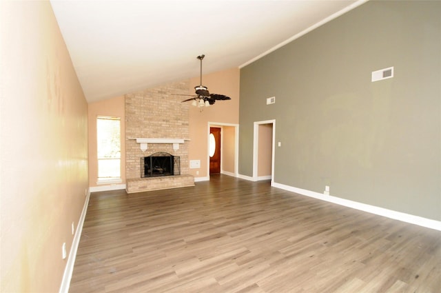 unfurnished living room with baseboards, high vaulted ceiling, wood finished floors, and a ceiling fan