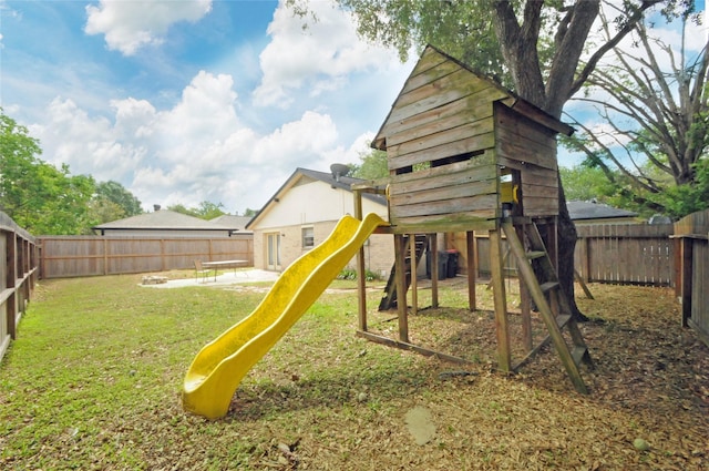 view of jungle gym featuring a fenced backyard, a yard, and a patio area