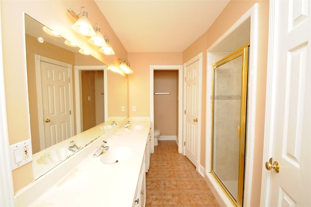 full bathroom with tile patterned floors, a stall shower, and a sink