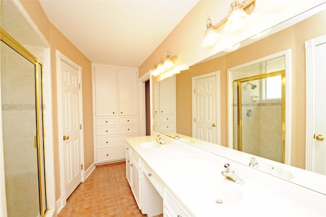 bathroom featuring double vanity, a sink, a shower stall, and tile patterned floors