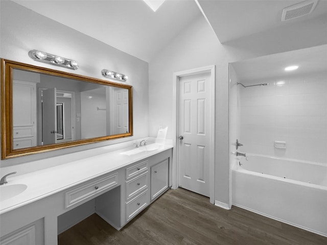 202 Essex Pl, Stafford, TX 77477 - full bathroom with visible vents, double vanity, vaulted ceiling, wood finished floors, and shower / tub combination