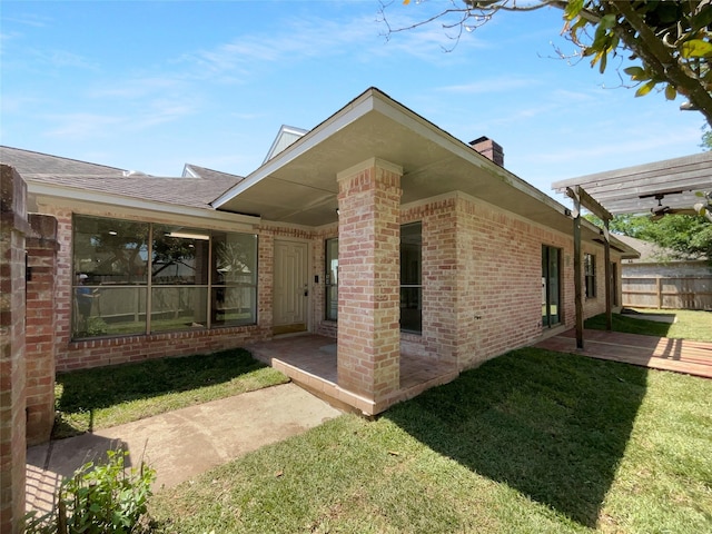 202 Essex Pl, Stafford, TX 77477 - exterior space featuring a pergola, a lawn, a chimney, fence, and brick siding