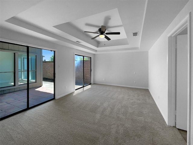 202 Essex Pl, Stafford, TX 77477 - spare room with ceiling fan, visible vents, carpet floors, a raised ceiling, and baseboards