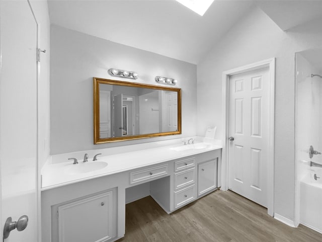 202 Essex Pl, Stafford, TX 77477 - full bath with double vanity, a sink, wood finished floors, and lofted ceiling