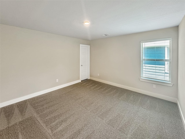 10716 Wild Chives, Conroe, TX 77385 - spare room with dark carpet, baseboards, and visible vents