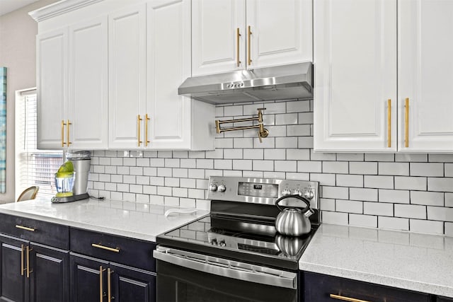 kitchen with dark cabinets, white cabinetry, stainless steel range with electric stovetop, under cabinet range hood, and decorative backsplash