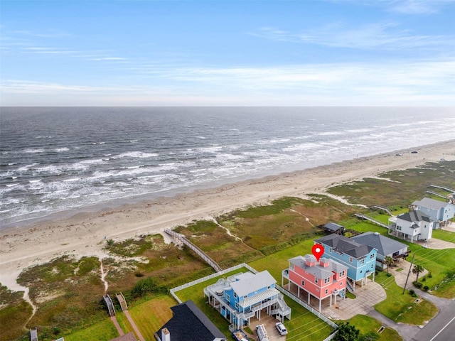 birds eye view of property featuring a beach view and a water view
