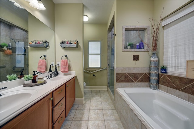 bathroom featuring a shower stall, tile patterned floors, a bath, and a sink