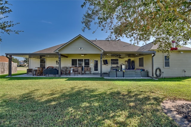 rear view of house with a patio area, ceiling fan, and a lawn