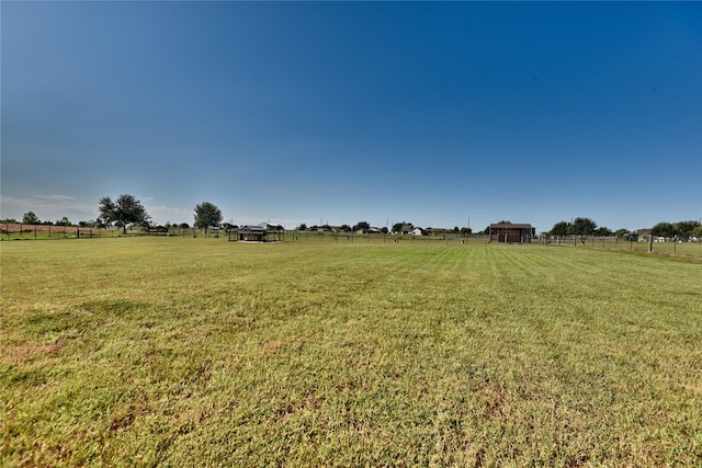 view of yard featuring a rural view and fence