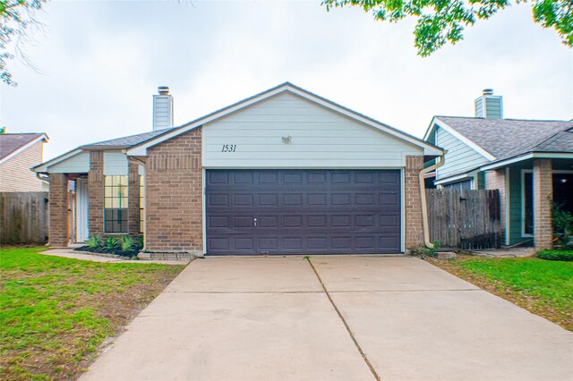 1531 Miller Ave, Katy, TX 77493 - single story home featuring a chimney, driveway, fence, and brick siding
