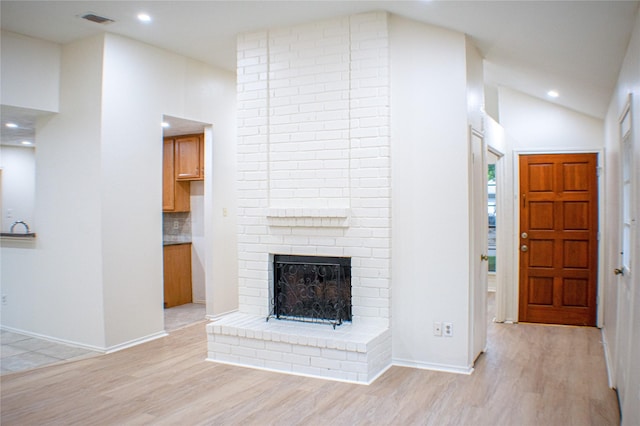 1531 Miller Ave, Katy, TX 77493 - unfurnished living room with vaulted ceiling, a fireplace, recessed lighting, light wood-style floors, and visible vents