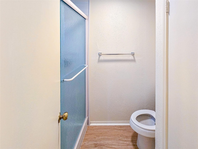 1531 Miller Ave, Katy, TX 77493 - bathroom featuring toilet, baseboards, a stall shower, and wood finished floors