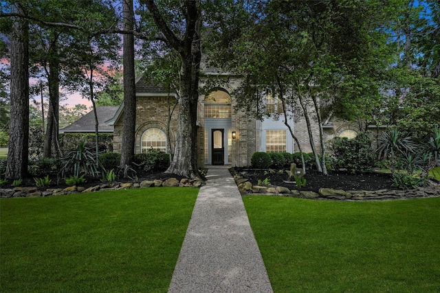 2023 Forest Garden Dr, Kingwood, TX 77345 - view of front of property featuring a yard, brick siding, and a shingled roof