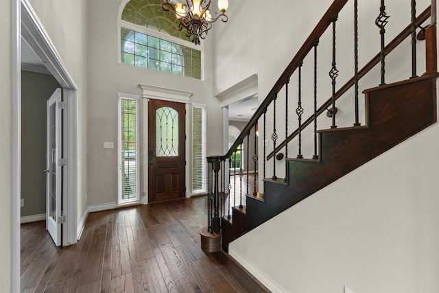 2023 Forest Garden Dr, Kingwood, TX 77345 - entryway with a chandelier, baseboards, a high ceiling, hardwood / wood-style flooring, and stairway