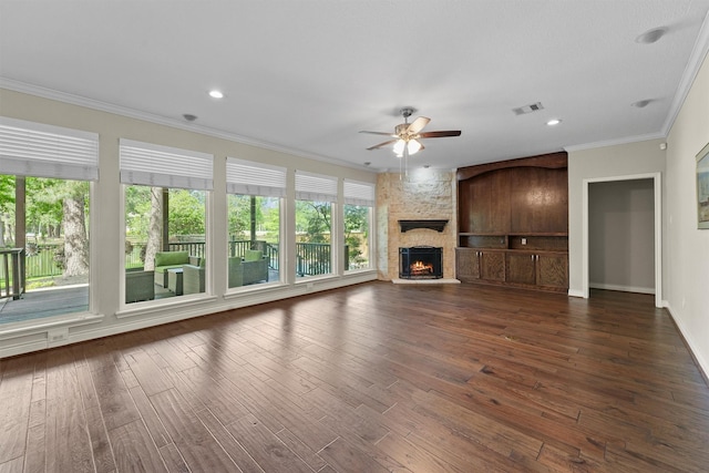 2023 Forest Garden Dr, Kingwood, TX 77345 - unfurnished living room featuring ceiling fan, dark wood finished floors, ornamental molding, baseboards, and a fireplace
