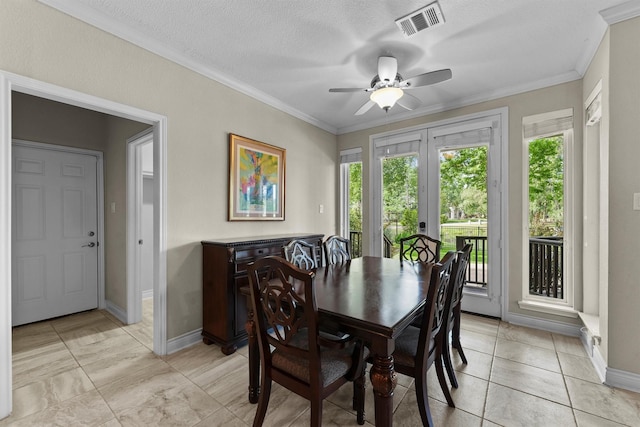 2023 Forest Garden Dr, Kingwood, TX 77345 - dining room with crown molding, baseboards, ceiling fan, a textured ceiling, and french doors