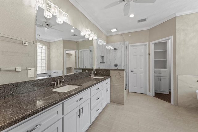 2023 Forest Garden Dr, Kingwood, TX 77345 - bathroom featuring ceiling fan, crown molding, a stall shower, and double vanity