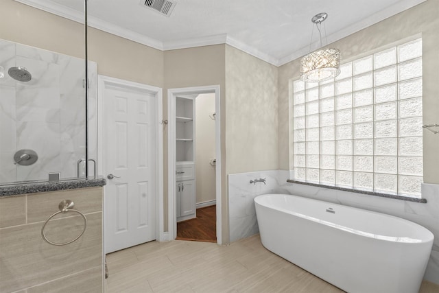 2023 Forest Garden Dr, Kingwood, TX 77345 - full bathroom with a stall shower, a freestanding bath, crown molding, tile walls, and a chandelier