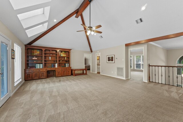 2023 Forest Garden Dr, Kingwood, TX 77345 - unfurnished living room with beam ceiling, a skylight, high vaulted ceiling, light colored carpet, and ceiling fan