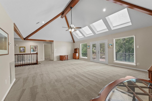 2023 Forest Garden Dr, Kingwood, TX 77345 - unfurnished living room with carpet floors, a skylight, beam ceiling, a ceiling fan, and high vaulted ceiling