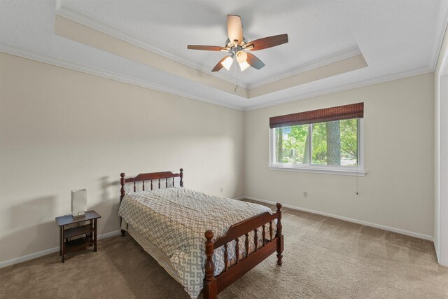 2023 Forest Garden Dr, Kingwood, TX 77345 - bedroom featuring a tray ceiling, ornamental molding, light colored carpet, and baseboards