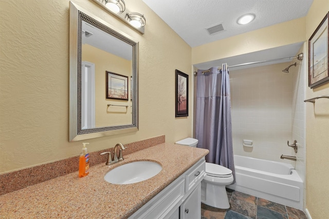 2023 Forest Garden Dr, Kingwood, TX 77345 - full bath featuring a textured wall, stone tile flooring, toilet, shower / bath combination with curtain, and vanity