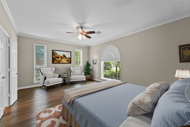 2023 Forest Garden Dr, Kingwood, TX 77345 - bedroom with wood-type flooring, crown molding, a textured ceiling, ceiling fan, and baseboards