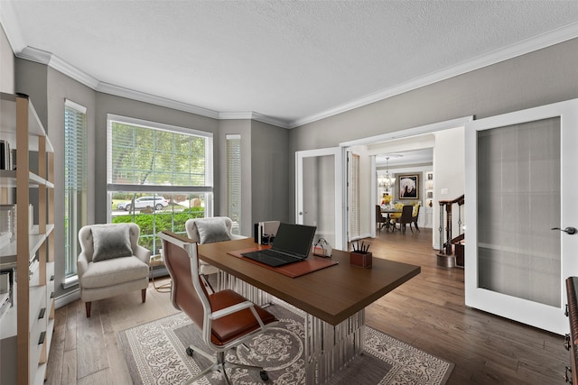 2023 Forest Garden Dr, Kingwood, TX 77345 - office with crown molding, a textured ceiling, hardwood / wood-style flooring, a chandelier, and french doors