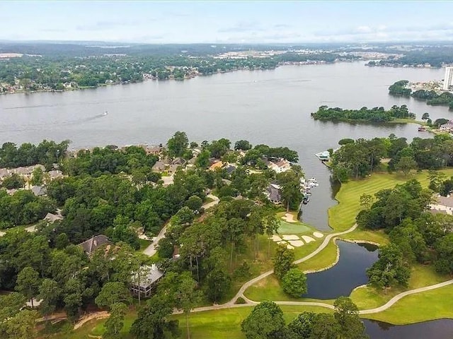 drone / aerial view featuring view of golf course and a water view