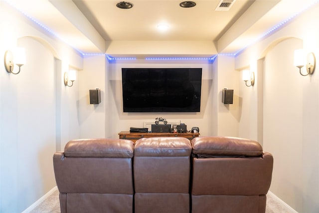 carpeted home theater featuring visible vents and baseboards