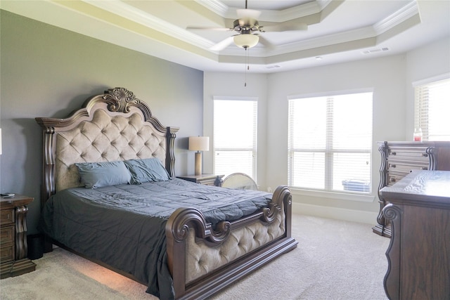 carpeted bedroom featuring crown molding, a raised ceiling, visible vents, baseboards, and a ceiling fan