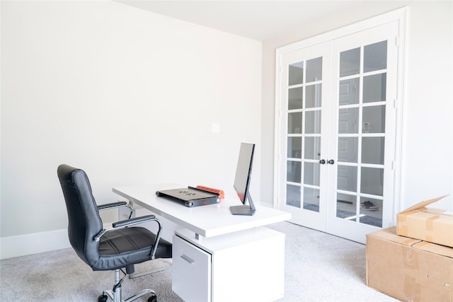 office with light carpet and french doors