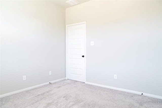 empty room featuring visible vents, carpet, and baseboards