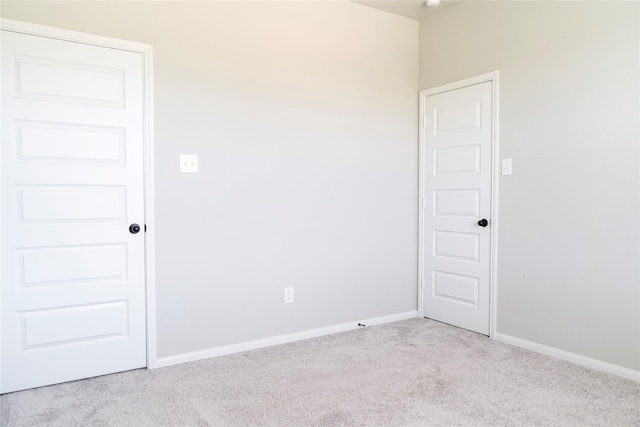 carpeted spare room with baseboards