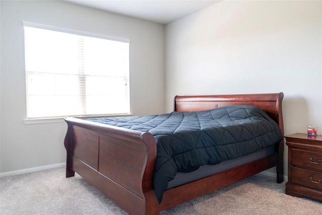 bedroom featuring carpet flooring and baseboards