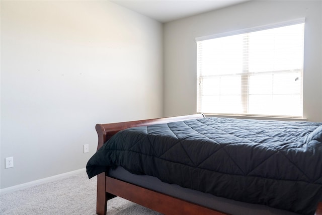 bedroom featuring baseboards and carpet floors