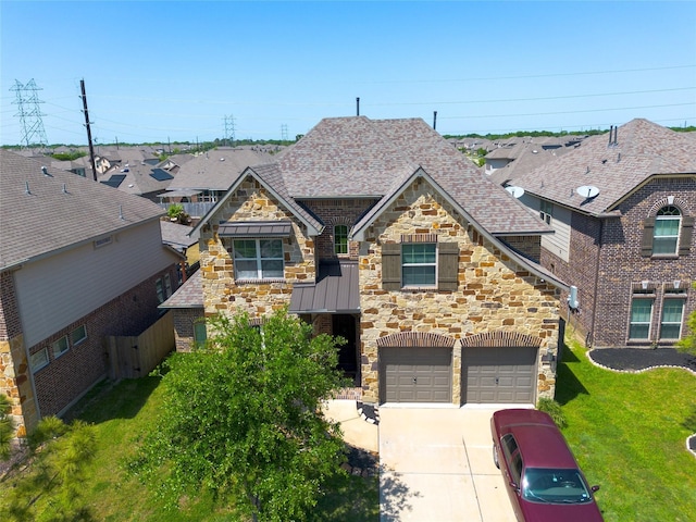 craftsman inspired home featuring stone siding, roof with shingles, a front lawn, concrete driveway, and an attached garage