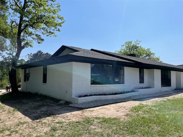 view of property exterior with brick siding